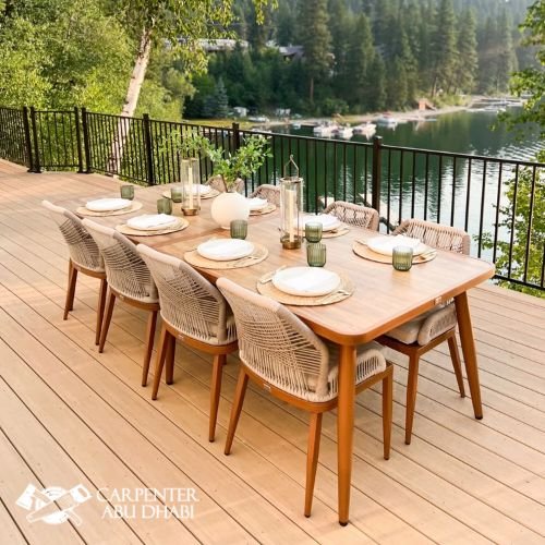 Scenic outdoor dining, wooden deck, woven chairs, elegant table setting, lake view, peaceful atmosphere.