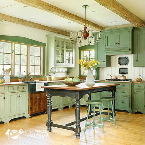 Vintage farmhouse kitchen with green cabinets.